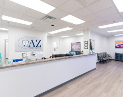 patient smiling at team member while laying in dental chair in AZ Dental